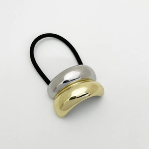 Detailed shot of two-tone gold and silver metal accent on high-elasticity ponytail holder