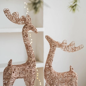 Set of two rose gold hollow iron Christmas reindeer statues with glittering finish
