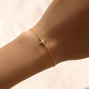 Close-up of golden S925 sterling silver thin chain bracelet with a diamond star charm