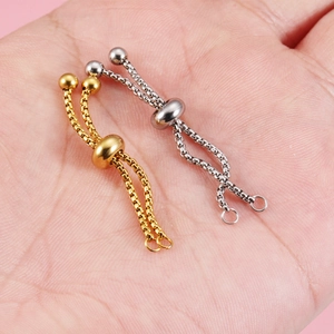 Adjustable stainless steel slide chain rings in gold and silver finish on hand