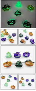 Luminous Halloween pumpkin hair claw clip showing vibrant green glow in the dark effect