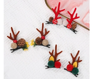 Detail of Christmas reindeer antler hair clips with pine cones and festive berries