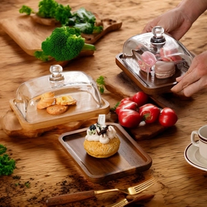 Rectangular acacia wood butter dish with glass lid holding colorful macarons and cakes