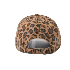 Detail of the adjustable metal buckle and leopard print pattern on the baseball cap