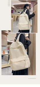Detail eines cremeweißen minimalistischen Rucksacks mit gewebtem Kordelzug und Hauptfach