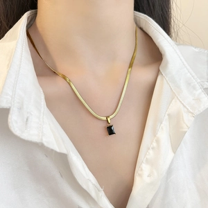 Elegant gold flat snake bone chain necklace with a rectangular green zircon pendant charm