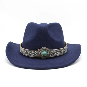 Detail of dark blue western cowboy hat with ethnic woven band and turquoise stone accent