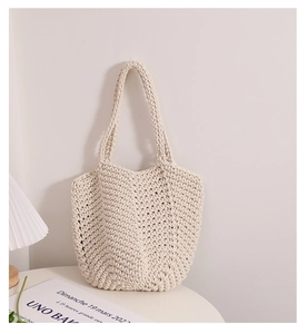 Close-up of beige thick cotton rope woven tote bag on a round table with a stylish lamp