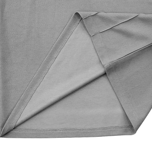 Detailed macro view of grey waffle knit fabric showing premium stitching and texture