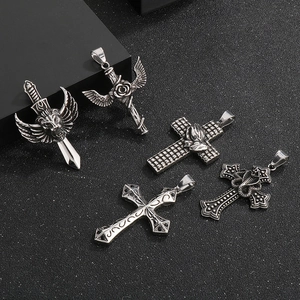 Detailed macro view of five gothic stainless steel pendants with lions, roses, and crosses