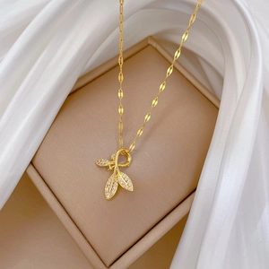 Luxurious gold titanium steel leaf pendant necklace with micro-pave crystals on white silk