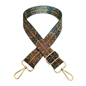 Macro detail of adjustable bohemian wide shoulder strap with golden metal lobster clasps