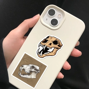 Detailed view of gothic animal skull stickers applied to a smartphone case for DIY decoration