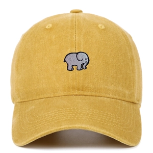 Close-up of elephant embroidery detail on mustard yellow washed cotton baseball cap