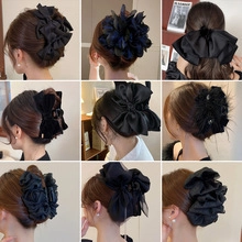 Detailed grid of black floral and bow hair claws featuring elegant fabric ribbon designs