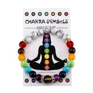 Colorful 7 Chakra crystal bead yoga bracelet on informative symbol meaning card