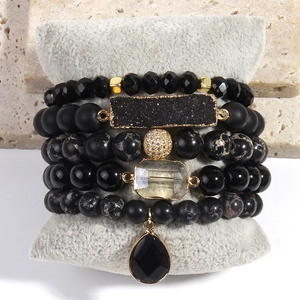 Detail of 5PCS bohemian stacked bracelets with black matte beads and natural stone pendants