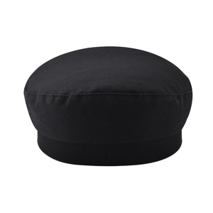 Close-up of black rivet baker boy hat showing fine twill fabric and stitching detail