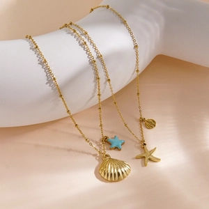 Summer ocean style necklace with gold shells and blue starfish charms on bead chains