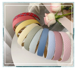 Selection of floral and plaid fabric headbands displayed with decorative roses