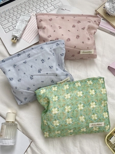 Floral and geometric canvas makeup bags with zipper closure and brand label