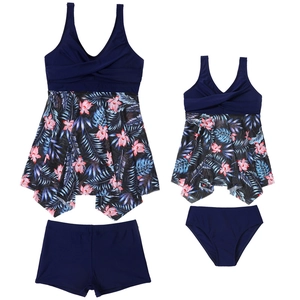 Detail view of navy blue two-piece family swimwear with vibrant tropical floral prints