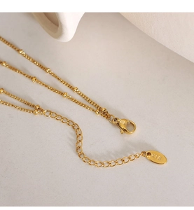 Detail of gold necklace lobster clasp and adjustable extension chain with K18 tag