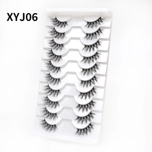 Detailed macro shot of 10 pairs of XYJ06 cat-eye wispy false eyelashes in a white tray