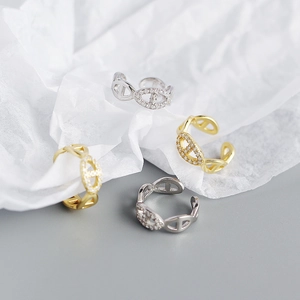 Close-up of gold and silver chain link open rings with sparkling cubic zirconia inlay