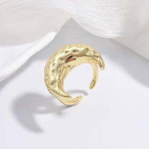 Detailed view of irregular hammered texture on gold open ring with vintage finish