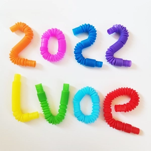 Colorful stretchable pop tubes arranged to spell 2022 and LVOE on white background