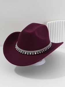 Detail of burgundy cowboy hat with sparkling silver bead chain and rhinestone fringe