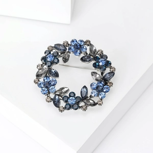 Elegant rhinestone flower wreath brooch with blue crystals for fashion suits