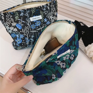 Detailed view of floral jacquard makeup bags with simple wish label and secure zipper