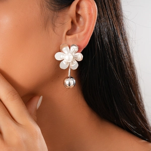 Silver flower drop earrings with white pearls and polished sphere on female model