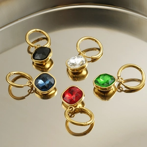 Macro shot of 18K gold plated stainless steel earrings with colorful zircon gemstones