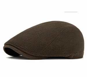 Detailed side view of coffee color knit flat cap showing textured wool ribbing detail