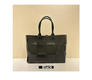 Detailed view of the wide-woven leather pattern on this black tote bag for women
