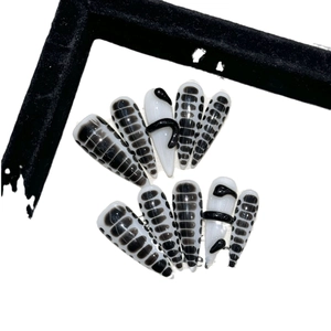 Black snake stiletto press-on nails with 3D embossed snake texture and dark python patterns