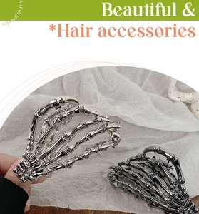 Close-up of gothic skeleton hand hair claws in silver and gun black metal finishes