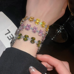 Detail view of double-layer zircon bracelets with yellow, pink, and green stones