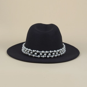 Close-up of black fedora hat with three layers of elegant white pearls on the band