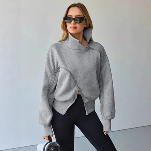 Detail of light grey sweatshirt featuring diagonal zipper and ribbed cuffs on the sleeve