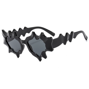 Futuristic Y2K punk sunglasses with black irregular wavy frames and dark lenses