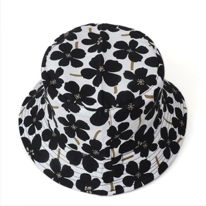 Close-up of black and white floral pattern cotton sun hat with precise brim stitching