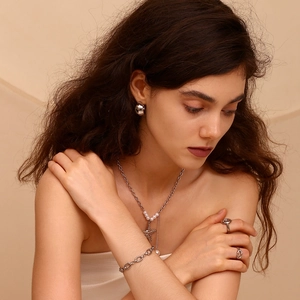 Detail view of gold-plated 14K stainless steel chain jewelry with pearl accents