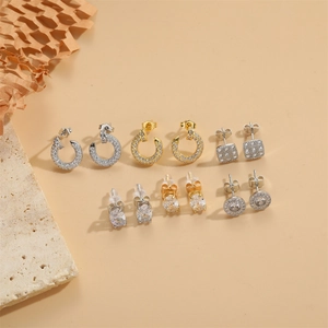 Selection of minimalist C-shape and geometric stud earrings with cubic zirconia stones
