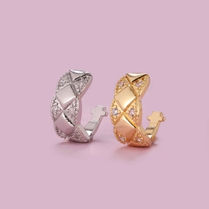Detail view of quilted pattern ear cuffs in gold and silver with zircon accents