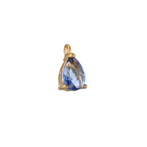 Close-up of gold plated teardrop pendant featuring a faceted blue zircon stone setting