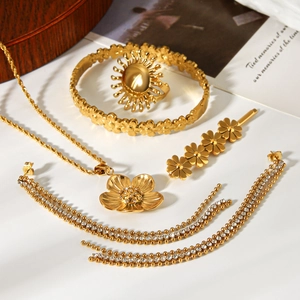 Detailed view of luxury gold-plated flower jewelry set with sparkling tassels and crystals